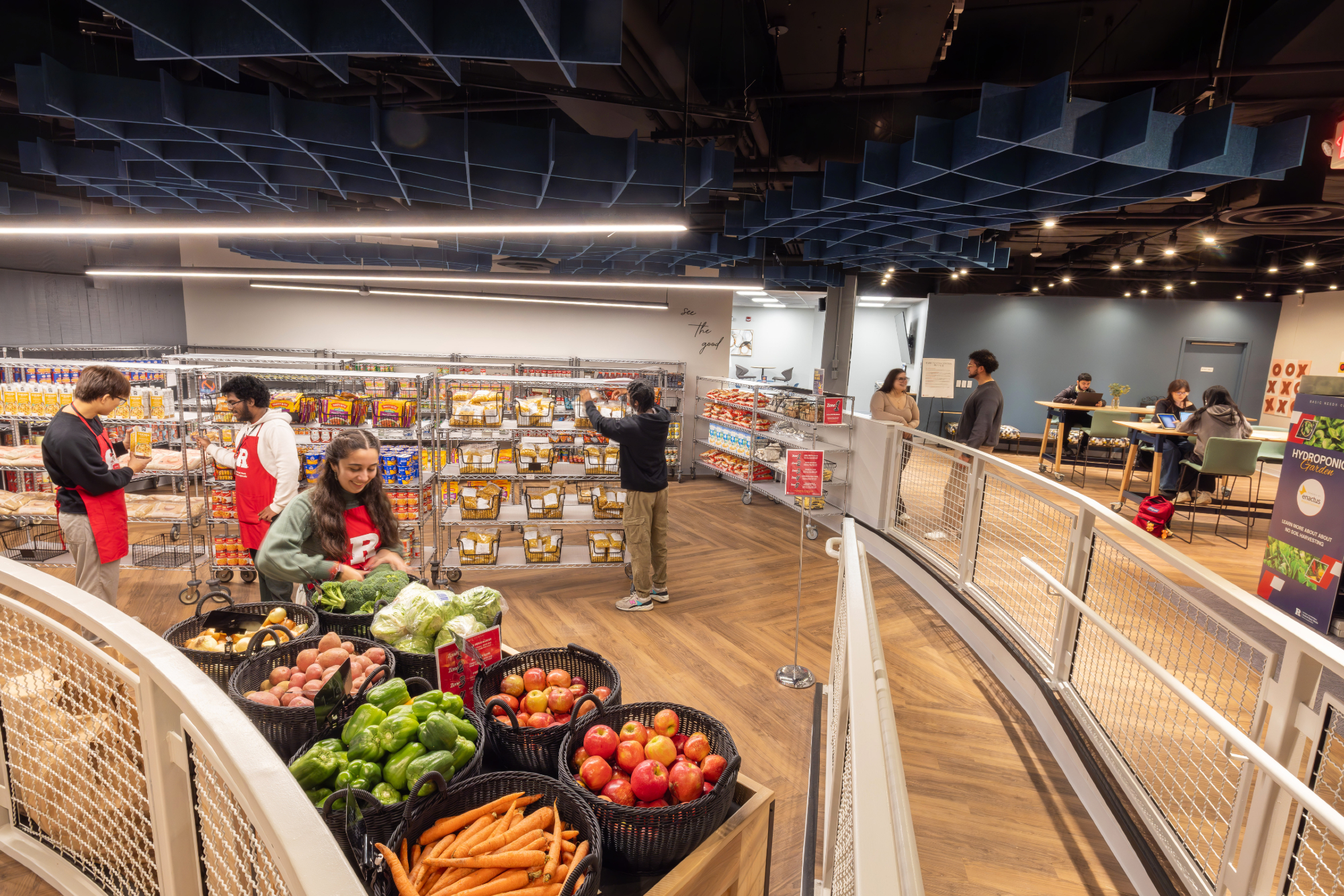Rutgers basic needs pantry with customers shelved foods and fresh fruits and vegetables at the front.