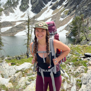 McKenna smiling at the camera while on a hike.